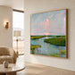 Marshlight Reverie painting on a pale wall beside a rounded lounge chair.