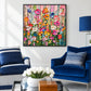 Petal Cascade painting above blue seating in a bright white living room.