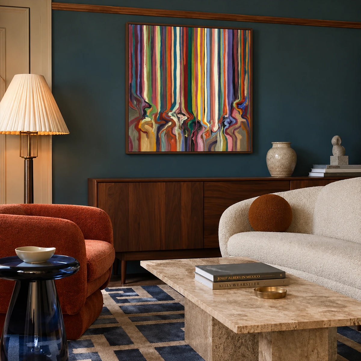 Chromatic Current painting above a wooden credenza beside curved cream seating.