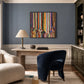 Chromatic Current painting above a wooden desk against a blue-gray wall.