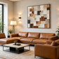 Timber Mosaic painting above a brown leather sectional in a bright living room.