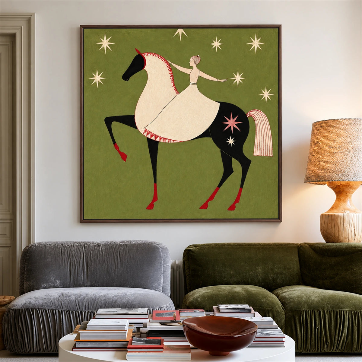 Starlit Rider painting above a two-tone sofa and round wooden coffee table.
