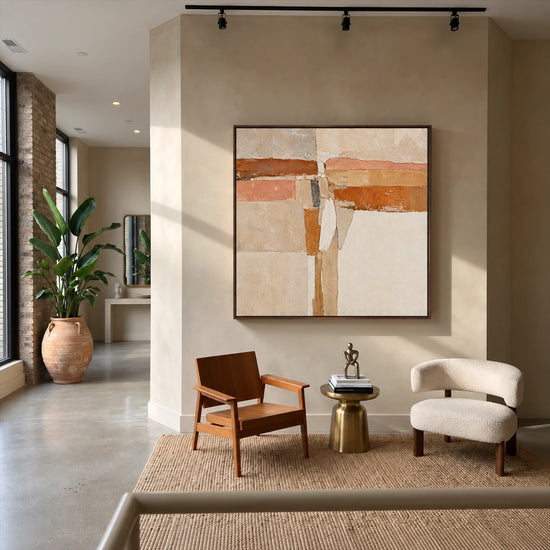 Terracotta Crossing painting above two lounge chairs in a neutral sitting area.