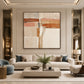 Terracotta Crossing painting above a cream sofa in a softly lit living room.