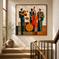 Amber Ensemble painting beside a stair railing in a sunlit entryway.