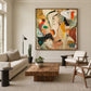 Ochre Fragments painting above a pale sofa beside a wooden lounge chair.