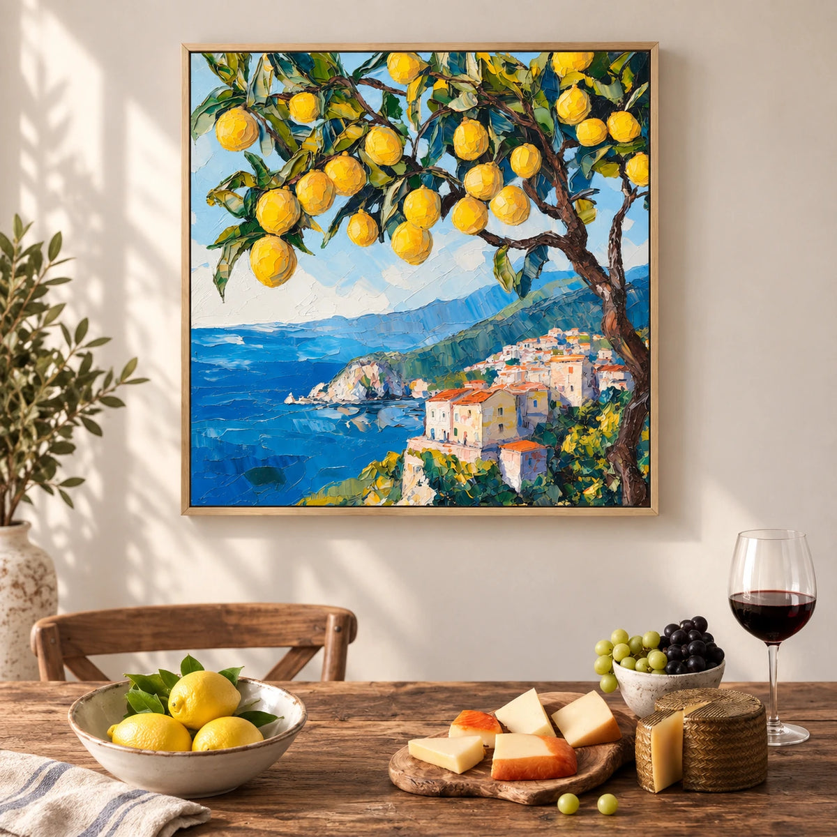 Lemon Coast painting above a dining table set with lemons and a wine glass.