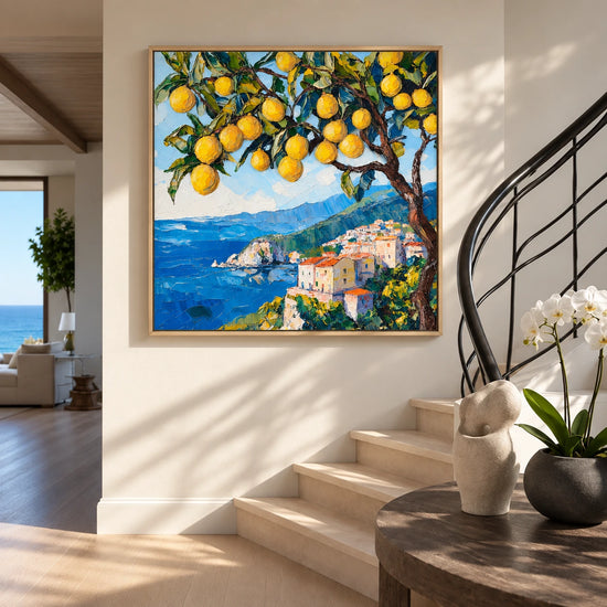 Lemon Coast painting beside a curved staircase in a sunlit entryway.