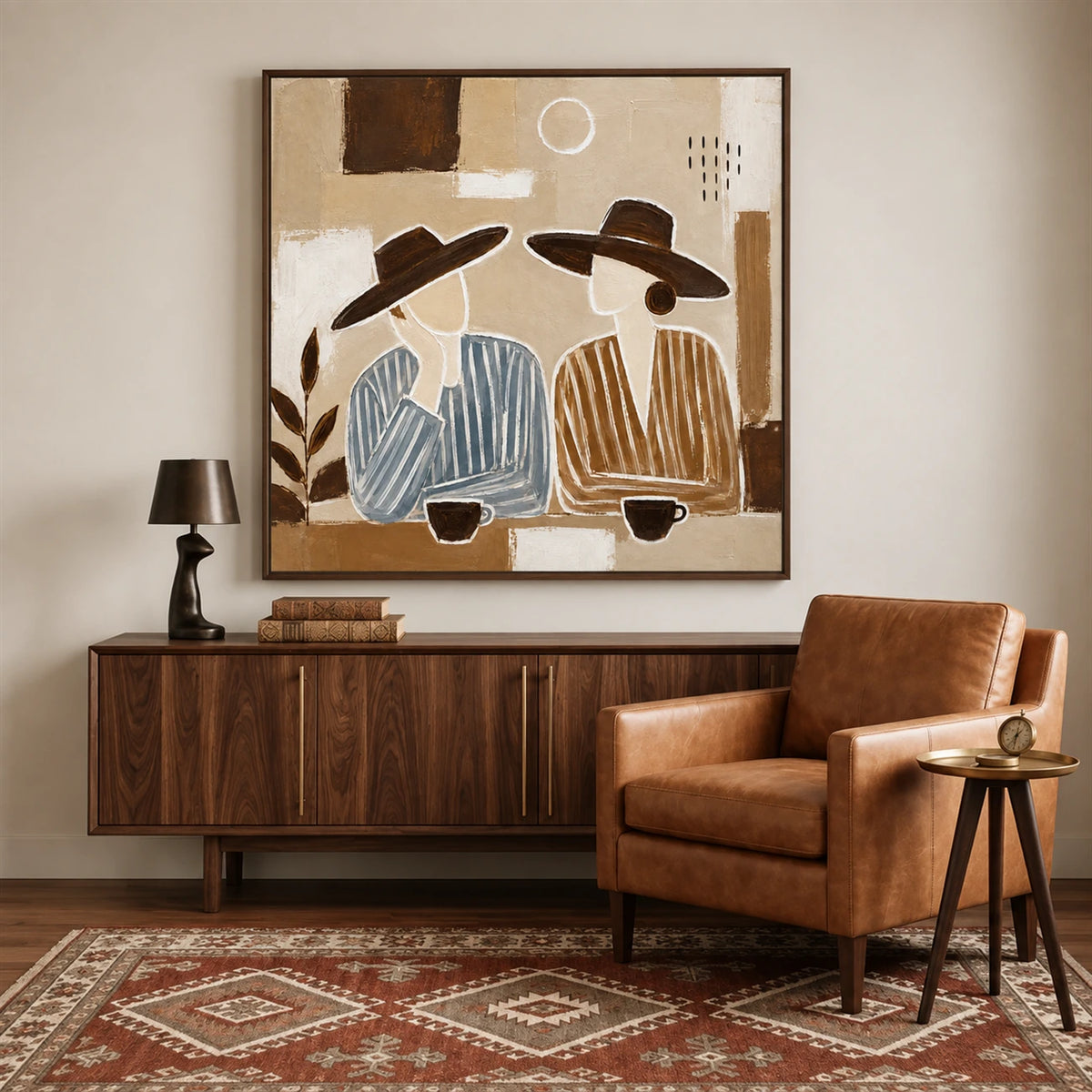Coffee Companions painting above a dark wooden sideboard beside a brown leather armchair.