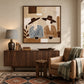 Coffee Companions painting above a wooden sideboard beside a cushioned chair and patterned rug.