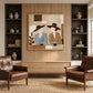 Coffee Companions painting between built-in shelves above wooden cabinetry and leather chairs.