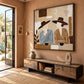Coffee Companions painting above a low wooden console in a warm terracotta-toned room.