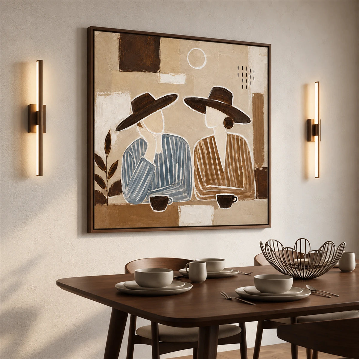 Coffee Companions painting above a round dining table set with cups, between two wall lights.