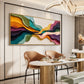 Chromatic Strata painting above curved dining chairs beside a white table.