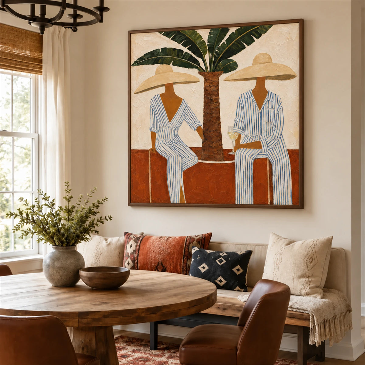 Palmside Leisure painting above cushioned dining seating beside a round wooden table.