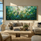 Jade Tesserae painting above a cream sectional in a bright coastal living room.