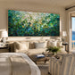 Jade Tesserae painting above a pale sofa beside a bed in a neutral suite.