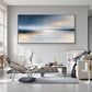 Silver Stillwater painting above gray seating and a low coffee table.