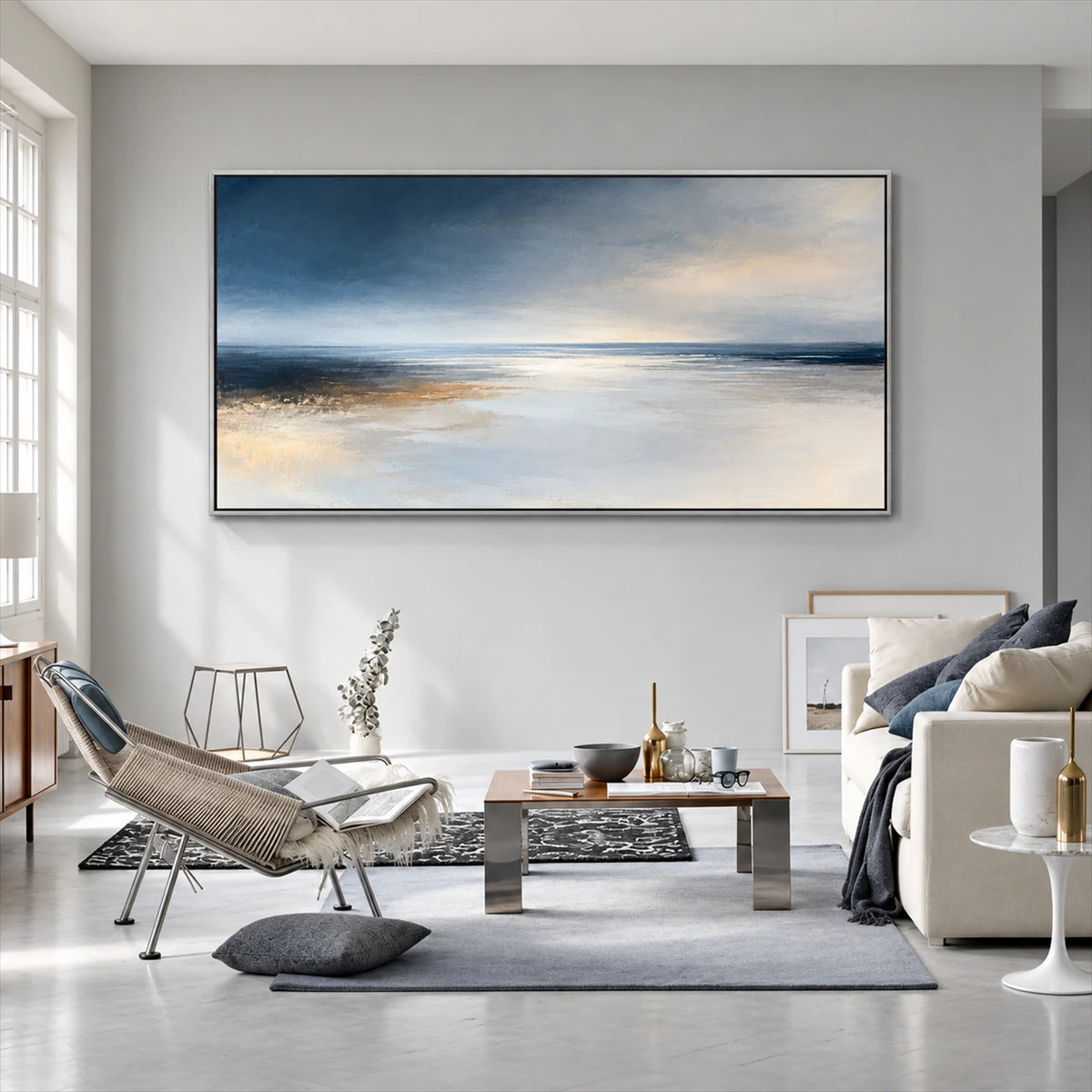 Silver Stillwater painting above gray seating and a low coffee table.