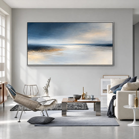 Silver Stillwater painting above gray seating and a low coffee table.