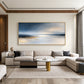 Silver Stillwater painting above a cream sectional beneath a wooden ceiling detail.