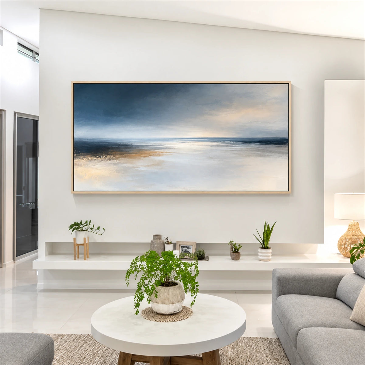 Silver Stillwater painting above a low white console beside a garden-facing window.