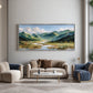 Alpine Waterways painting above neutral seating with blue striped chairs.