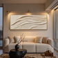 Linen Dunes painting above a cream sofa and round black coffee table.