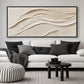 Linen Dunes painting above a white sofa with black cushions and round tables.