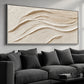 Linen Dunes painting above a dark gray sectional with matching cushions.