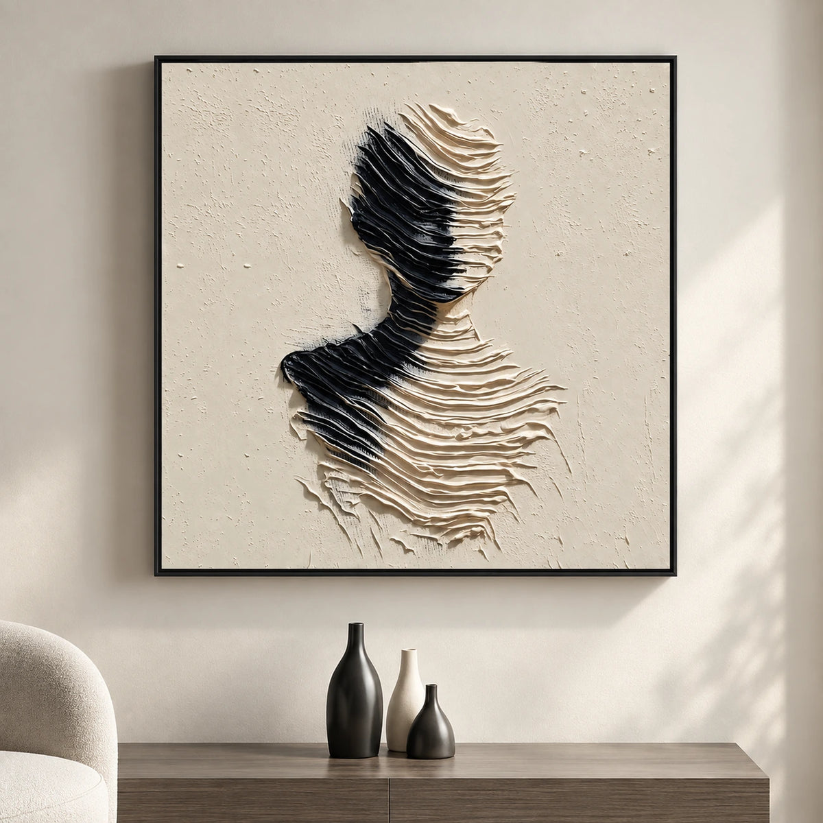 Sculpted Silence artwork above a console with three sculptural vases in a sunlit room.