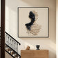 Sculpted Silence artwork beside a staircase above a wooden console.