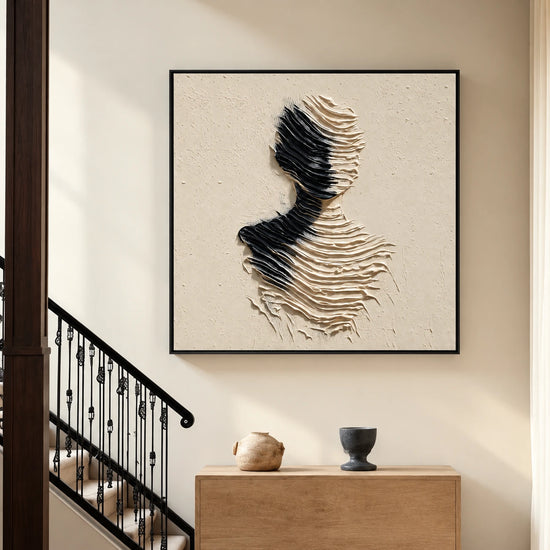 Sculpted Silence artwork beside a staircase above a wooden console.