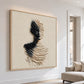 Sculpted Silence artwork on a bright living room wall beside a neutral sofa.