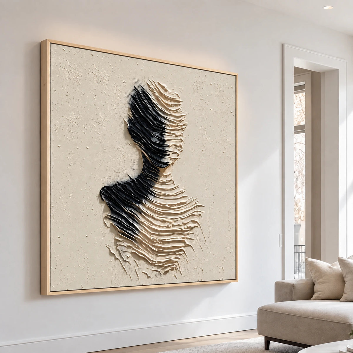 Sculpted Silence artwork on a bright living room wall beside a neutral sofa.