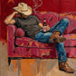 A cowboy settles into a deep crimson armchair, hat tipped low as a thin curl of smoke rises against the red wall. Full artwork without a frame.