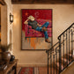 Cowboy Siesta artwork beside a wrought iron staircase and a wall lantern.
