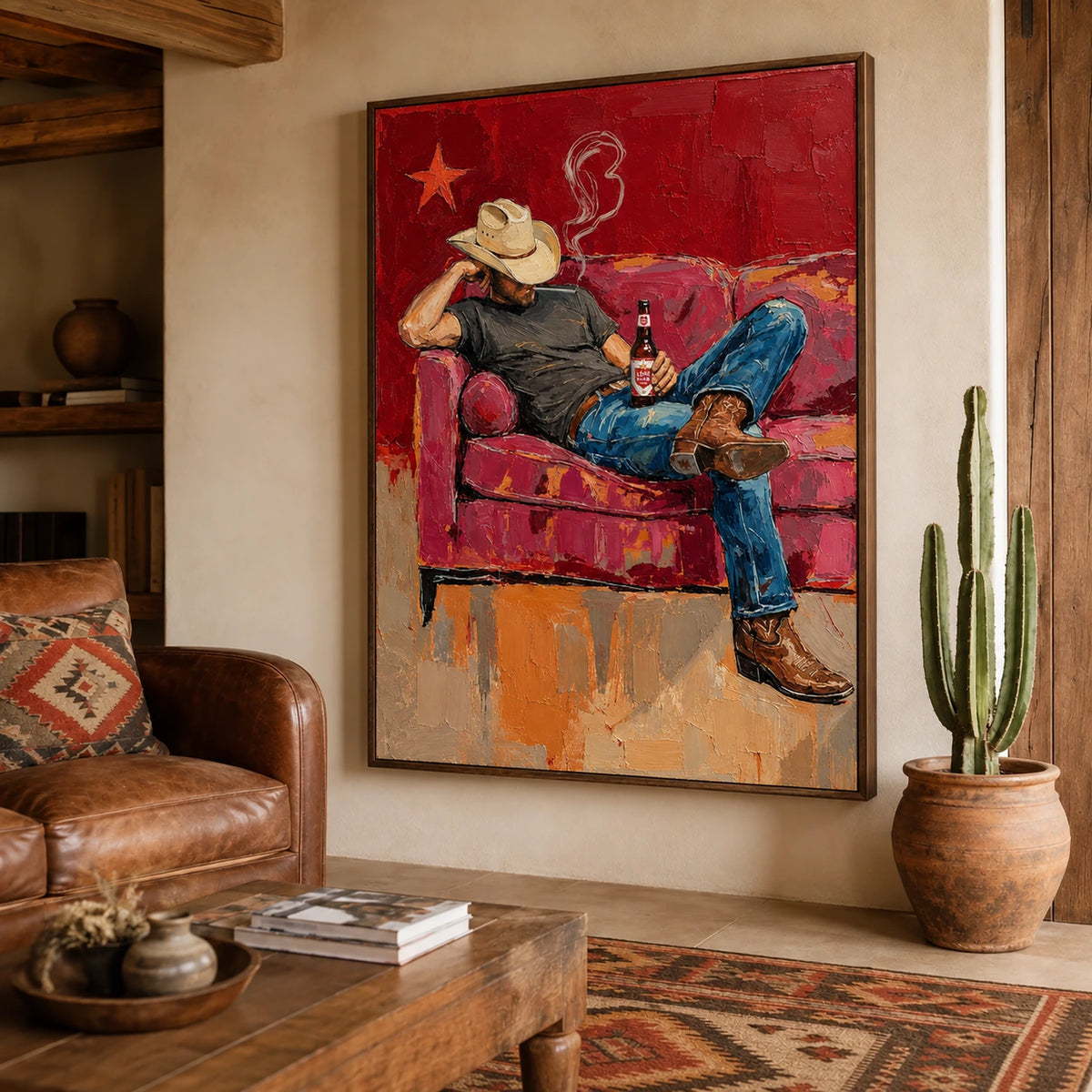 Cowboy Siesta artwork above a leather sofa beside a tall cactus.