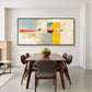 Citrine Balance painting above a dark wood dining table in a bright room.