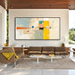 Citrine Balance painting above a brown sectional with white oval tables.