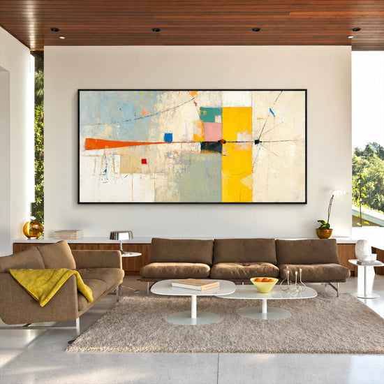 Citrine Balance painting above a brown sectional with white oval tables.