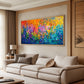 Chromatic Blossoms painting above a beige sofa beside warm wooden paneling.