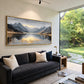 Mountain Stillness painting above a charcoal sofa beside a garden-facing window.