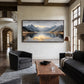 Mountain Stillness painting above a wooden coffee table between dark armchairs.