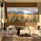 Meadow Distance painting above a cream sofa beside warm wood paneling.