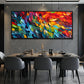 Prismatic Rhythm painting above a dark dining table.