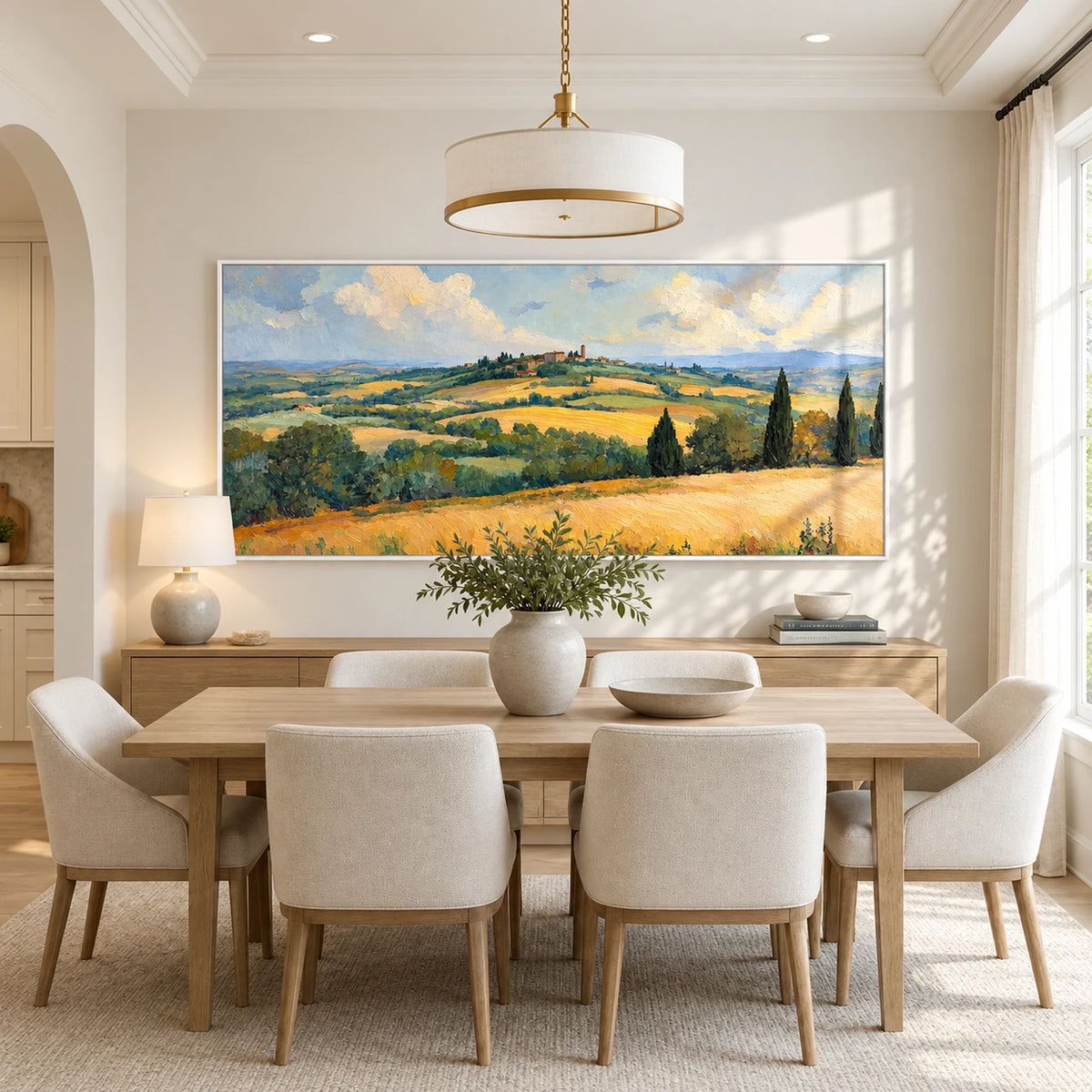 Golden Hills painting above a dining table with cream chairs.