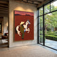 Crimson Reins painting on a tall wall beside a glass doorway.