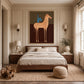 Copper Horseman painting above a bed in a paneled bedroom.
