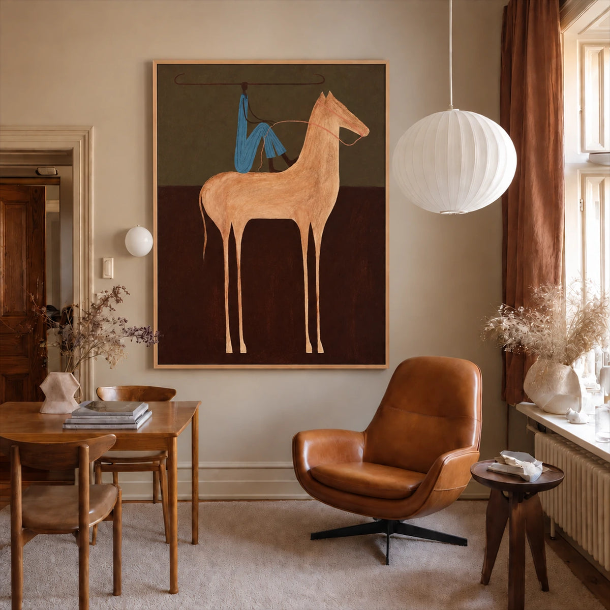 Copper Horseman painting above a desk beside a tan leather chair.
